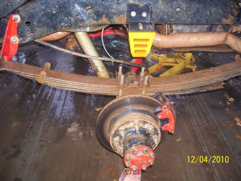 1978 Ford Bronco - Close-up view of the rear suspension and braking system of a vehicle.