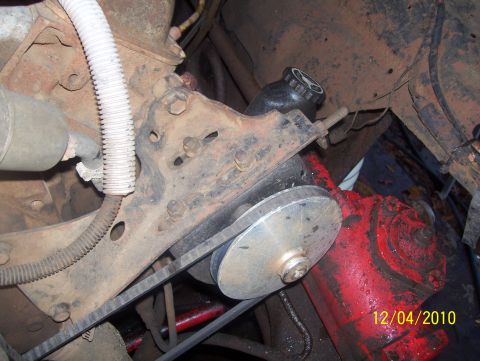1978 Ford Bronco - Engine component detail, likely a power steering pump assembly, with visible belt and pulley.