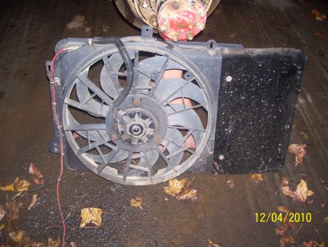 1978 Ford Bronco - Radiator fan assembly shown with wiring and part of a hub assembly in the background. Date stamp indicates 12/04/2010.