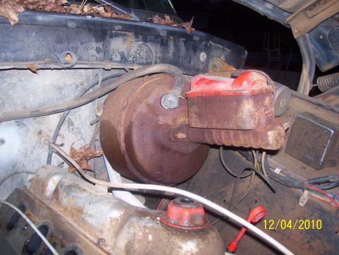 1978 Ford Bronco - Close-up view of a rusty brake booster and master cylinder assembly, likely from an older vehicle.