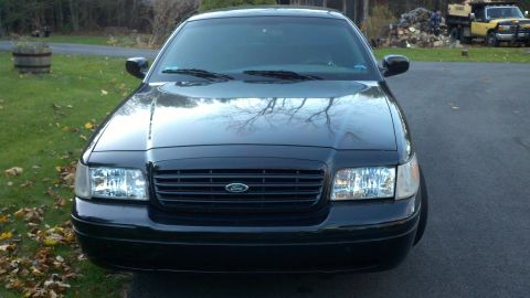 1999 Ford Crown Victoria - Front view of a black 1998 Ford Crown Victoria sedan.
