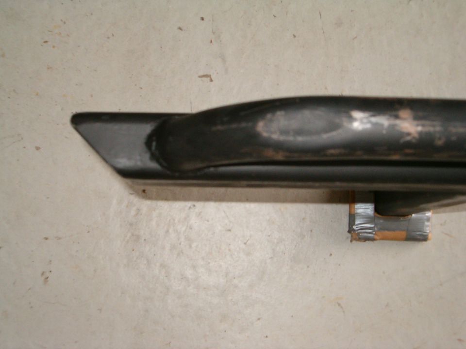 Black metal tube with angled end, attached with tape