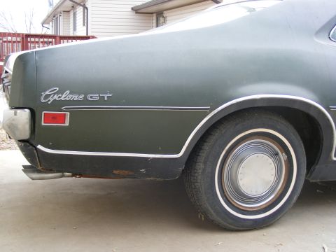 1971 Mercury Cyclone - The rear quarter panel of a 1971 Mercury Cyclone GT shows the distinctive badging and dual exhaust pipes.