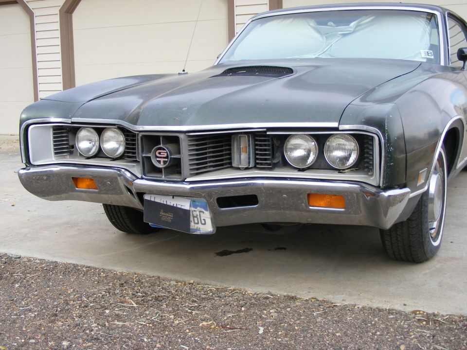 Dark green Mercury Cyclone GT front three-quarter view with quad headlights and hood scoop