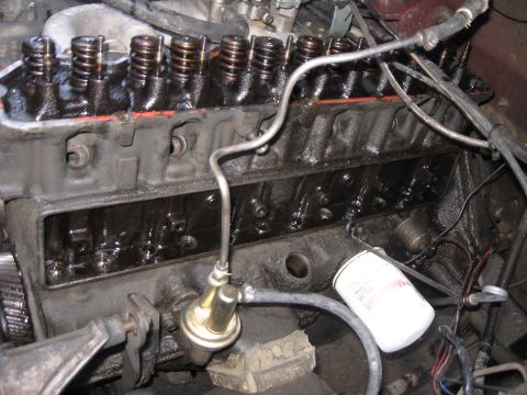 1981 Ford Bronco - V8 engine in the vehicle with the intake manifold removed, exposing the open lifter valley, pushrods and both banks of valve springs with o…