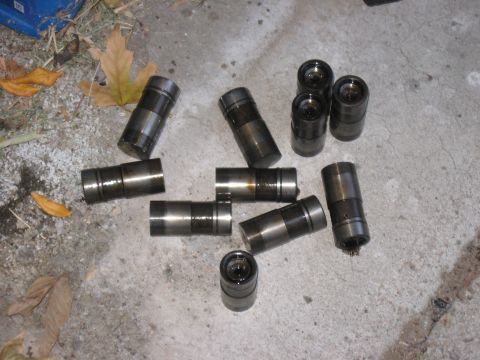 1981 Ford Bronco - Engine lifters laid out on concrete, possibly before or after installation.