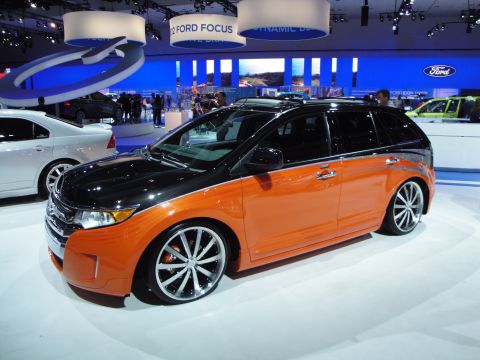 1993 Ford Taurus - This two-tone crossover SUV with custom wheels was displayed at an auto show, with signage indicating a 2012 Ford Focus.