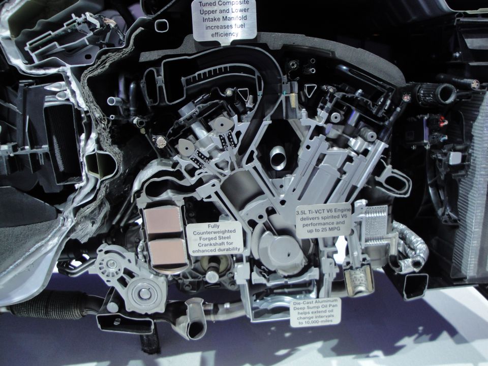 Cutaway engine with labels detailing its components and performance