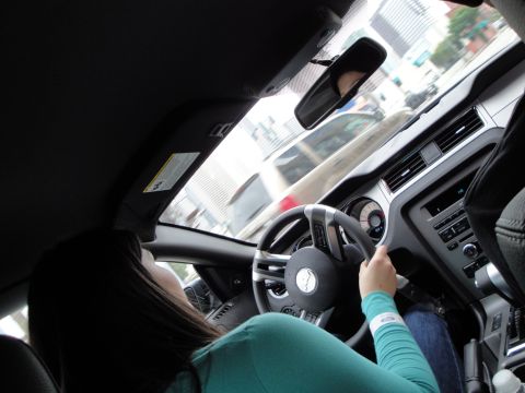 1993 Ford Taurus - View from the driver's seat of a car in traffic, with buildings visible in the distance.