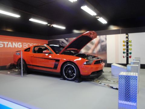 1993 Ford Taurus - Ford Mustang Boss 302 displayed with its hood open, next to a drag racing Christmas tree.