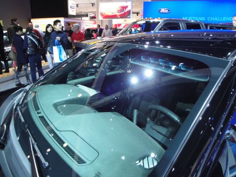 1993 Ford Taurus - View of the dashboard and interior of a Ford truck at an auto show, with people in the background.