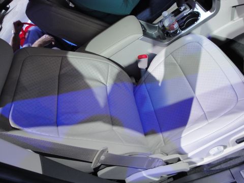 1993 Ford Taurus - The interior of a modern vehicle features perforated leather seats and a center console with cup holders.