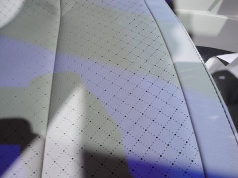 1993 Ford Taurus - Close-up of a perforated white leather car seat interior with a diamond pattern.