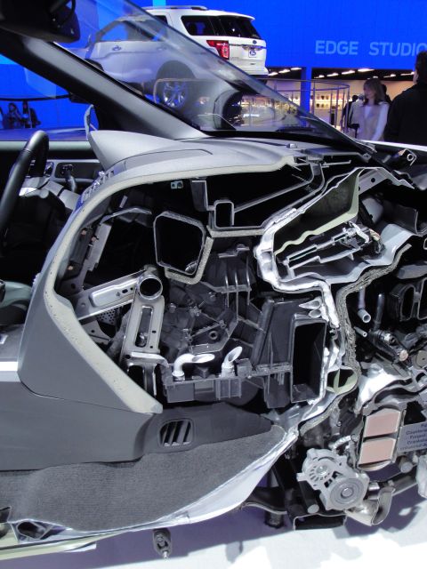 1993 Ford Taurus - Cutaway view of a vehicle's dashboard and HVAC system, with a white SUV visible behind it.