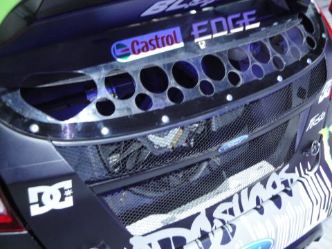 1993 Ford Taurus - This modified Ford Fiesta features racing decals and a prominent mesh grille revealing internal components.