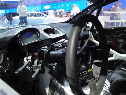1993 Ford Taurus - Interior view of a racing car, showing a digital display and a Sparco steering wheel.
