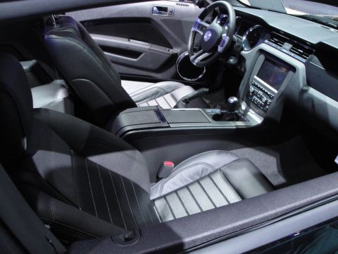 1993 Ford Taurus - The interior of a modern car features black leather seats with striped inserts and a touchscreen infotainment system.