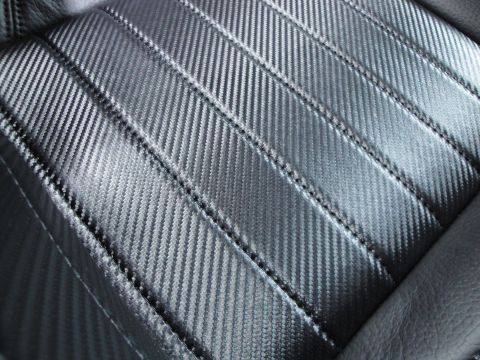 1993 Ford Taurus - Interior view of a car seat with a distinctive carbon fiber pattern and stitched detailing.