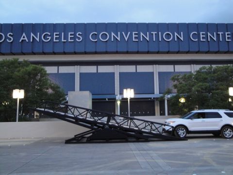 1993 Ford Taurus - A white SUV is parked near a large metal ramp outside the Los Angeles Convention Center.