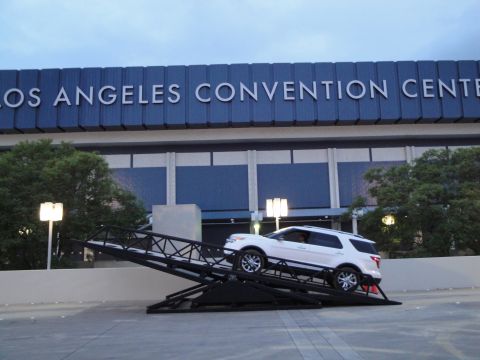 1993 Ford Taurus - A white Ford Explorer is positioned on a metal ramp outside the Los Angeles Convention Center.