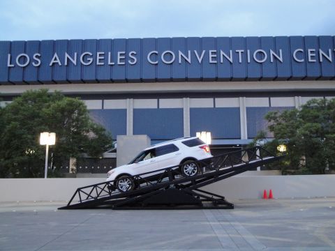 1993 Ford Taurus - A white SUV is positioned on a metal ramp structure outside the Los Angeles Convention Center.