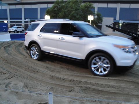1993 Ford Taurus - A white 2011 Ford Explorer navigates a sand course during an event.