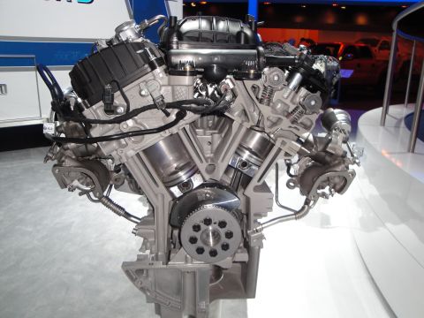 1993 Ford Taurus - A detailed cutaway shows the internal components of a V6 engine, including pistons and turbochargers.