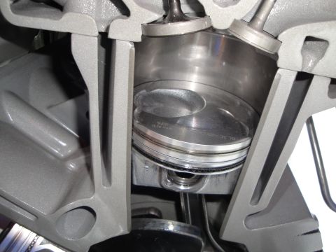 1993 Ford Taurus - Close-up view of a cutaway engine, revealing the piston and valve train components.