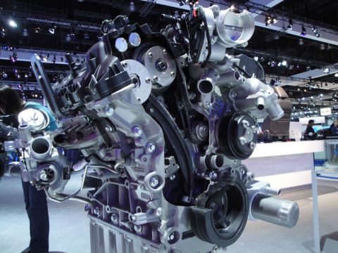 1993 Ford Taurus - Close-up view of a complex engine assembly on display.
