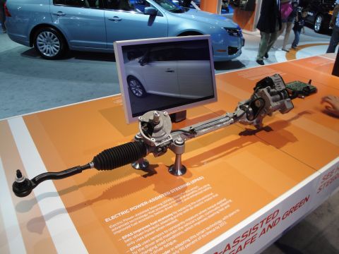 1993 Ford Taurus - An electric power steering system is displayed with informational text and a blue car in the background.