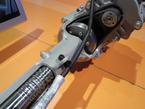 1993 Ford Taurus - Close-up of a steering rack and pinion mechanism, showing internal components like the worm gear and drive belt.