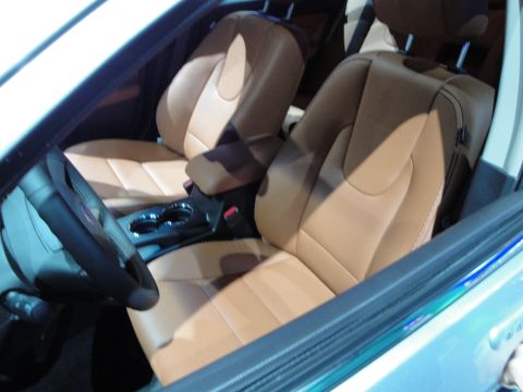 1993 Ford Taurus - Interior view of a vehicle tan leather seats, a steering wheel, and cup holders.