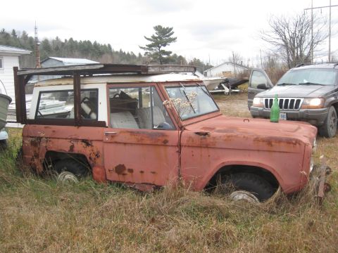 1981 Ford Bronco - Abandoned 1978 Ford Bronco in tall grass, with a Jeep Grand Cherokee behind it.