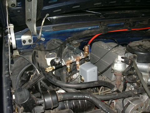 1991 Ford Bronco - I used a 6x6 shelf bracket and hose clamps to mount the manifold to the AC coil housing.