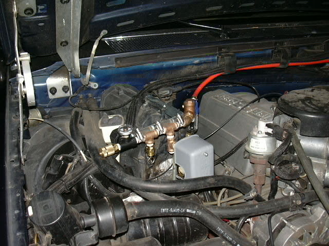 I used a 6x6 shelf bracket and hose clamps to mount the manifold to the AC coil housing.