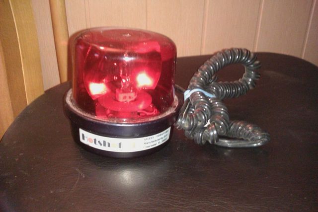 Red emergency light with coiled cord and 'Fetish 1' label