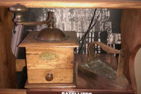 1991 Ford LTD Crown Victoria - A vintage coffee grinder and an antique iron are displayed on a wooden shelf.
