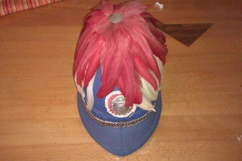 1991 Ford LTD Crown Victoria - A decorative hat with feathers and a chain is displayed on a wooden surface.