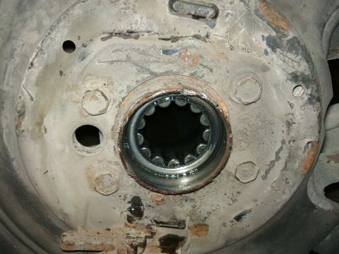 1998 Ford Crown Victoria - Close-up of a vehicle's axle hub, revealing the splined opening and signs of wear.