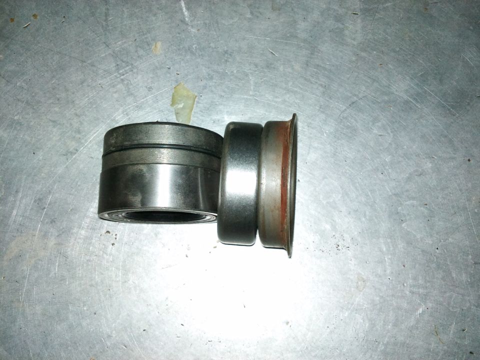Two axle bearings on a metal surface