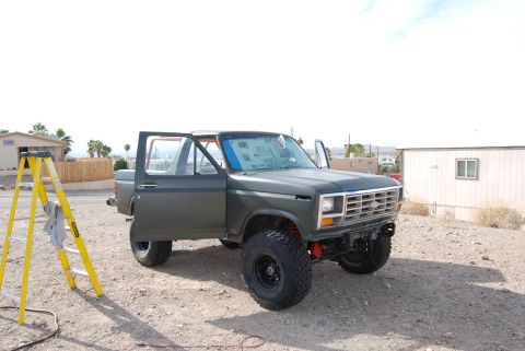 1982 Ford Bronco - Ford Bronco parked outside with doors open, a yellow ladder is nearby.