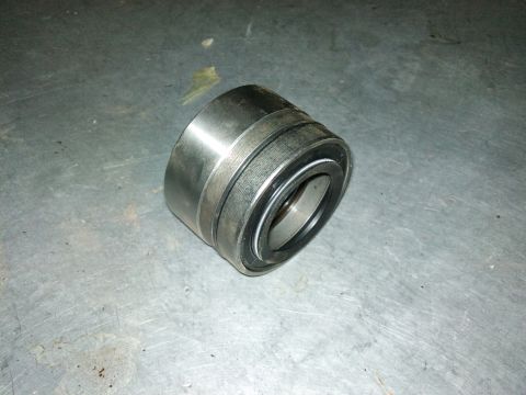 1998 Ford Crown Victoria - A single wheel bearing is shown on a textured metal surface, likely a workshop floor.