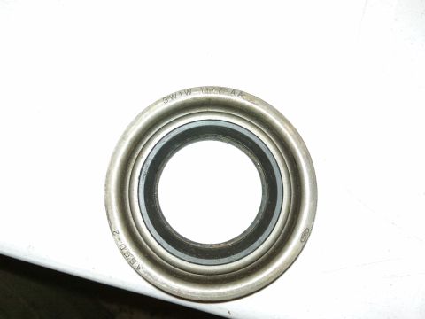 1998 Ford Crown Victoria - A close-up view of an axle bearing seal, showing stamped part numbers.