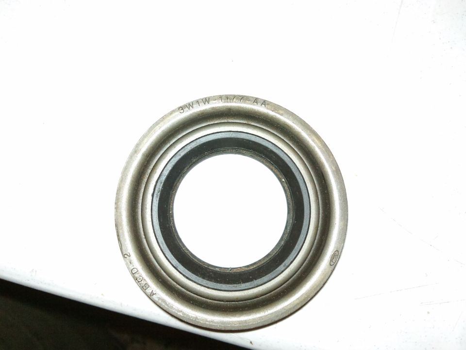 Axle bearing seal with part numbers 3W1W-1177-AA and ABGD-2 stamped on its metal casing