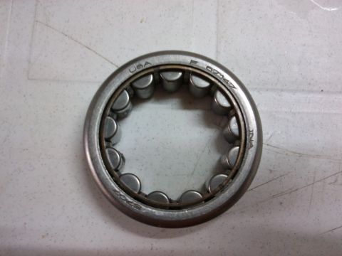 1998 Ford Crown Victoria - A close-up view of a roller bearing with various markings indicating its origin and part number.