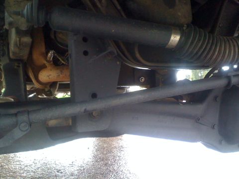 1989 Ford Bronco - Close-up view of the undercarriage of a 1989 Ford Bronco, highlighting its suspension and steering systems.