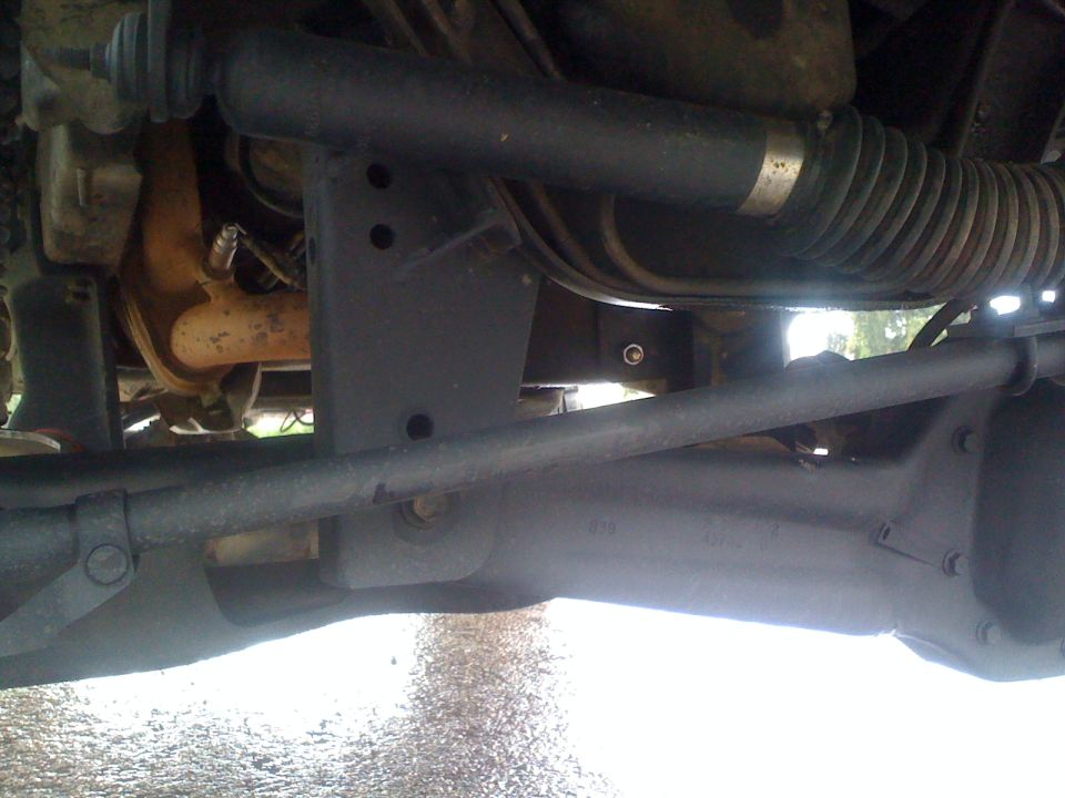 Undercarriage of a 1989 Ford Bronco showing suspension and steering components