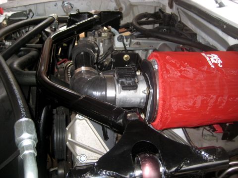 1996 Ford Bronco - Close-up of an engine bay a red K&N air filter and intake system.
