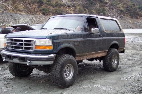 1995 Ford Bronco - This lifted 1995 Ford Bronco is shown in a muddy, off-road environment.