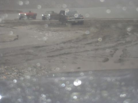 1979 Ford Bronco - Multiple pickup trucks are visible in a muddy outdoor scene, with numerous out-of-focus circles obscuring the view.
